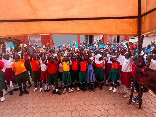 Children Kneel in Thanks as Blessing Books and Leaflets Are Shared in Uganda